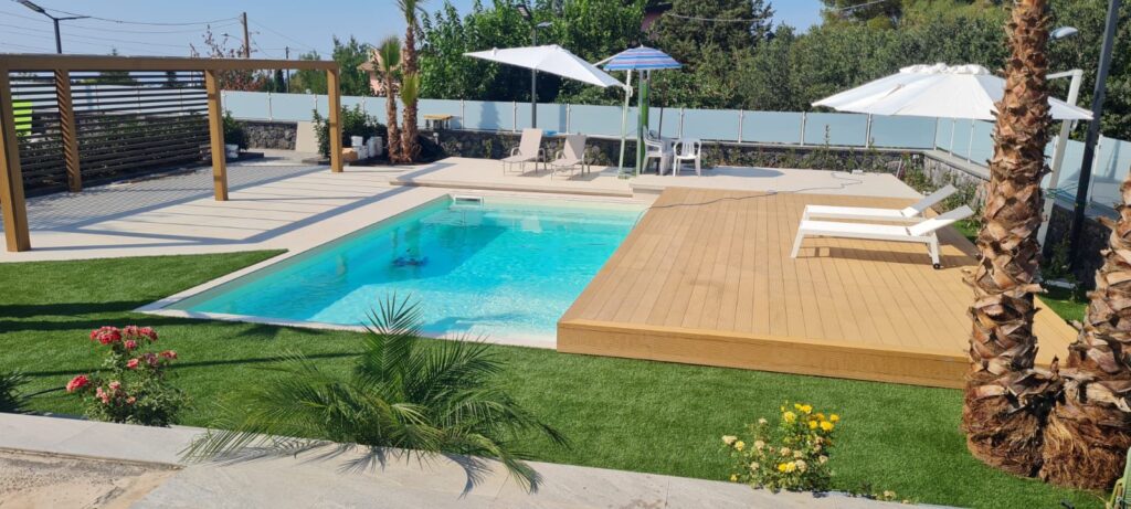 a pool with a deck and chairs